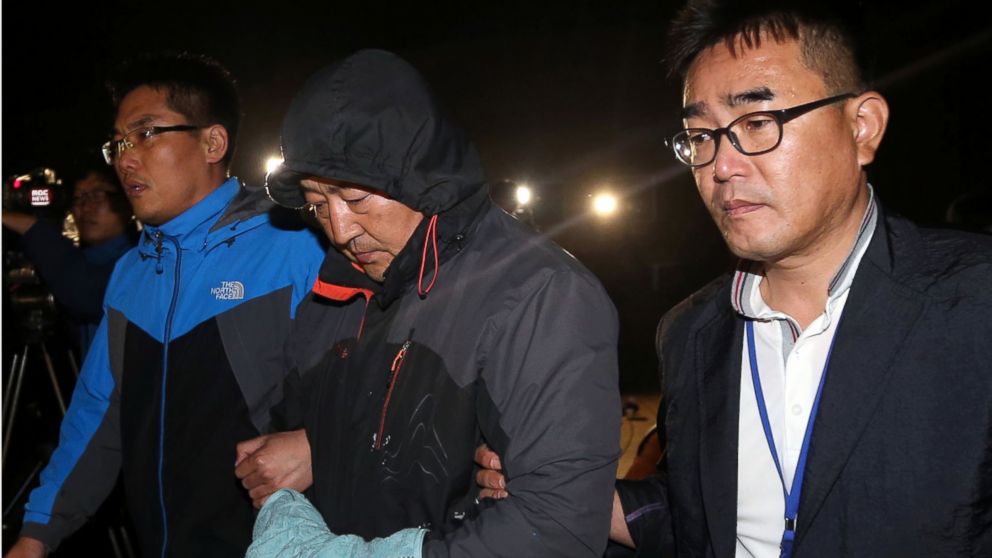 PHOTO: Lee Joon-seok, center, the captain of the sunken ferry Sewol in the water off the southern coast, leaves a court which issued his arrest warrant in Mokpo, south of Seoul, South Korea, April 19, 2014.