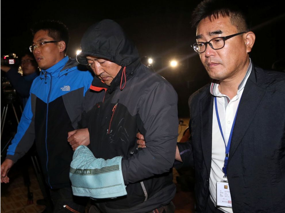 PHOTO: Lee Joon-seok, center, the captain of the sunken ferry Sewol in the water off the southern coast, leaves a court which issued his arrest warrant in Mokpo, south of Seoul, South Korea, April 19, 2014.