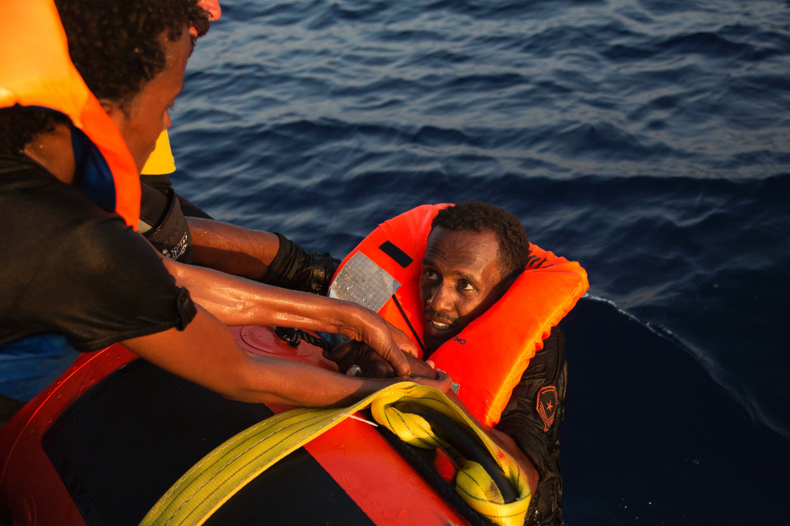 PHOTO: A migrant from Eritrea is helped after jumping into the water from a crowded wooden boat during a rescue operation in the Mediterranean sea, Aug. 29, 2016.