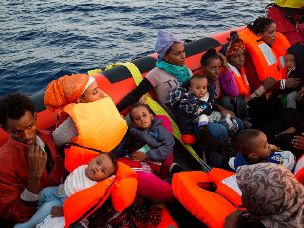PHOTO: Migrants from Eritrea hold their children after been rescued from a crowded wooden boat as they were fleeing Libya, about 13 miles north of Sabratha, Libya, Aug. 29, 2016.