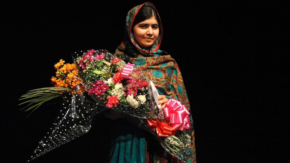 PHOTO: Malala Yousafzai poses with a bouquet after speaking during a media conference at the Library of Birmingham, in Birmingham, England, Oct. 10, 2014, after she was named as winner of The Nobel Peace Prize.