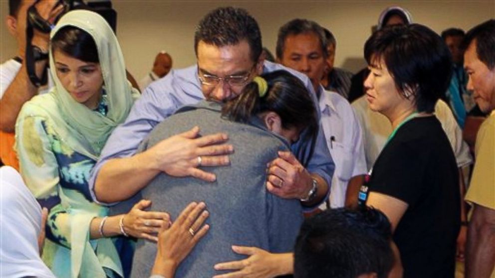 Malaysia's acting Transport Minister Hishammuddin Hussein, center, comforts a relative of passengers on board the missing Malaysia Airlines flight MH370 at a hotel in Putrajaya, Malaysia, Saturday March 29, 2014. 