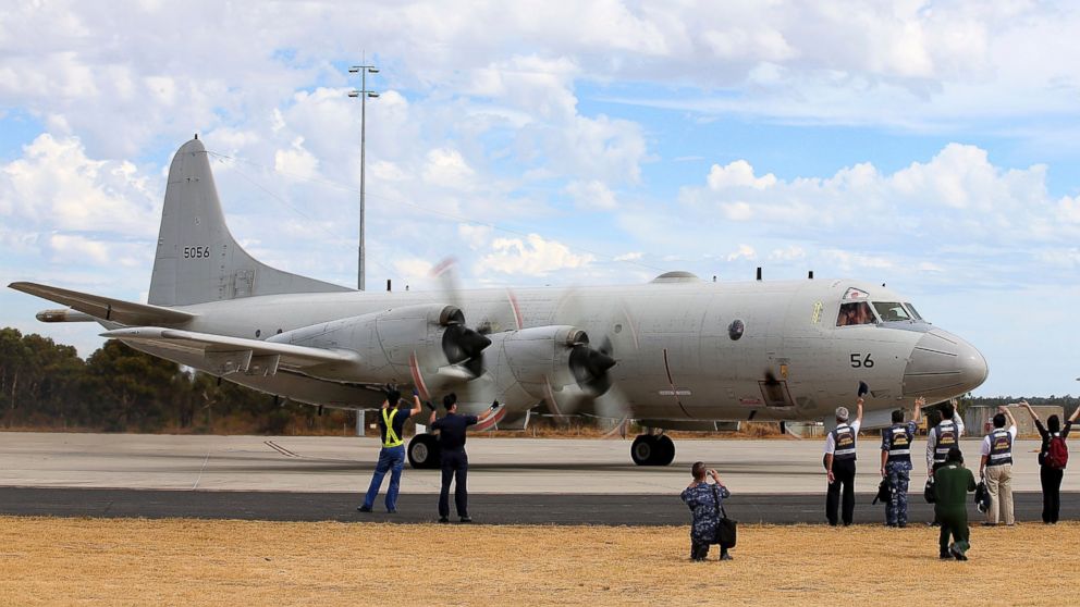 Japan Maritime Self-Defense Force farewell their P-3C Orion as it taxis from the Royal Australian Air Force Pearce Base to commence a search for possible debris from the missing Malaysia Airlines flight MH370, in Perth, Australia, March 24, 2014. 