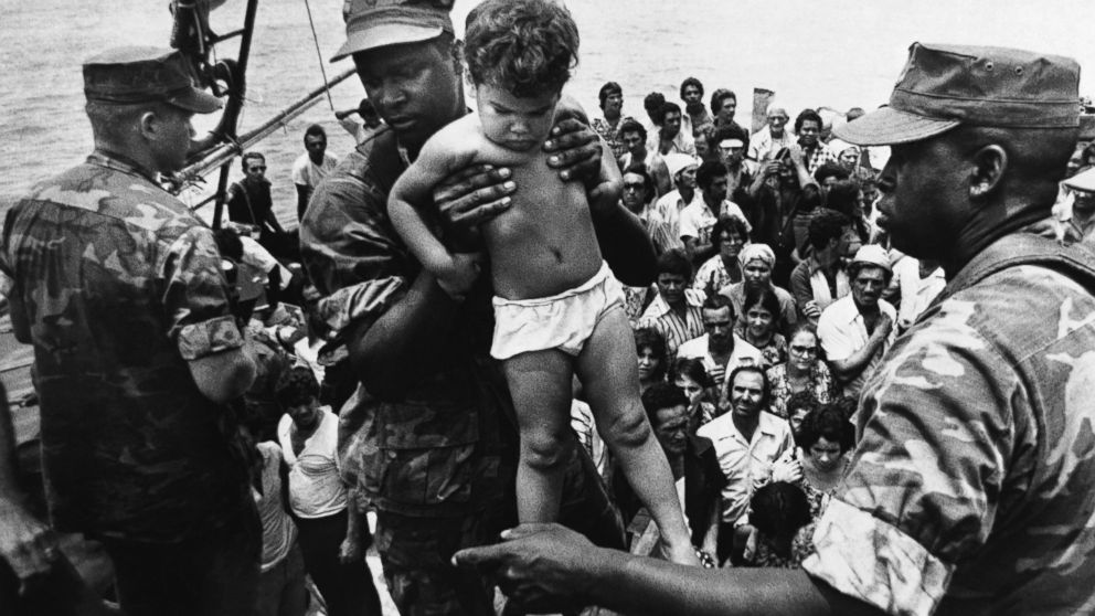 PHOTO: In 1980, Fidel Castro opened up the Mariel port in Cuba for residents to leave.  A U.S. Marine helped a young Cuban child off one of the refugee boats poured into Key West for weeks, May 10, 1980.  