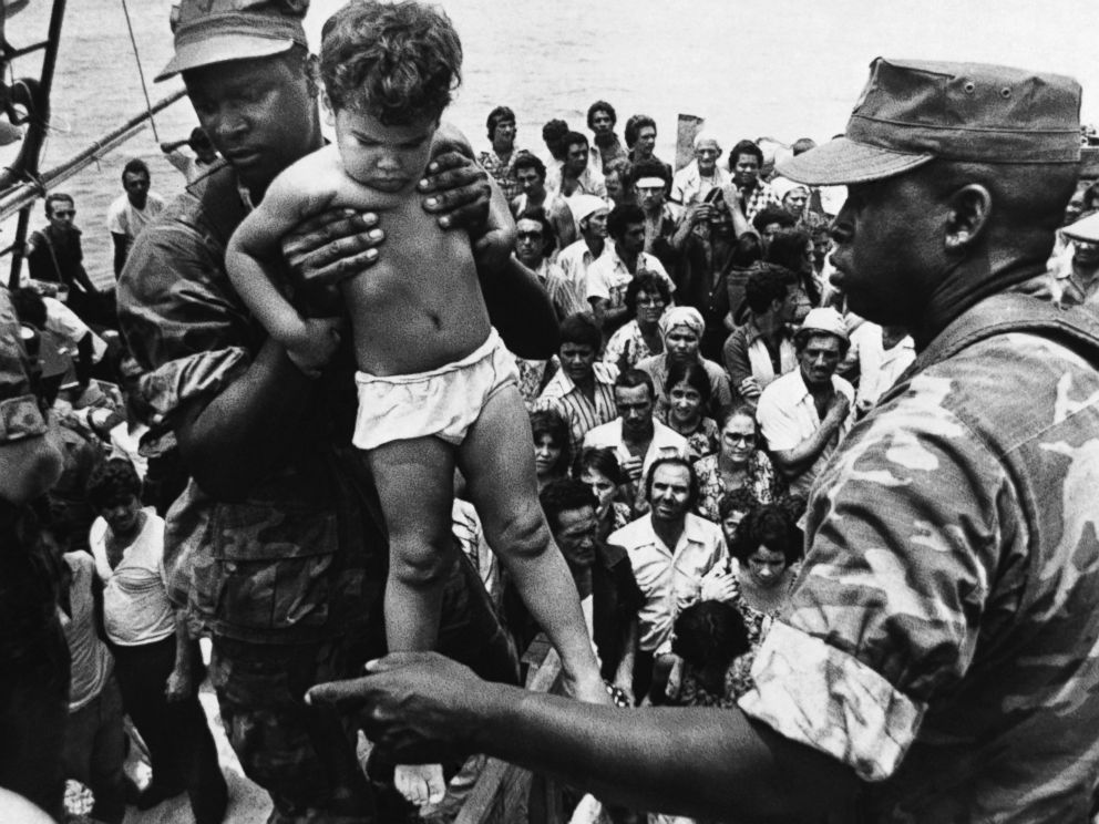 PHOTO: In 1980, Fidel Castro opened up the Mariel port in Cuba for residents to leave. A U.S. Marine helped a young Cuban child off one of the refugee boats poured into Key West for weeks, May 10, 1980.