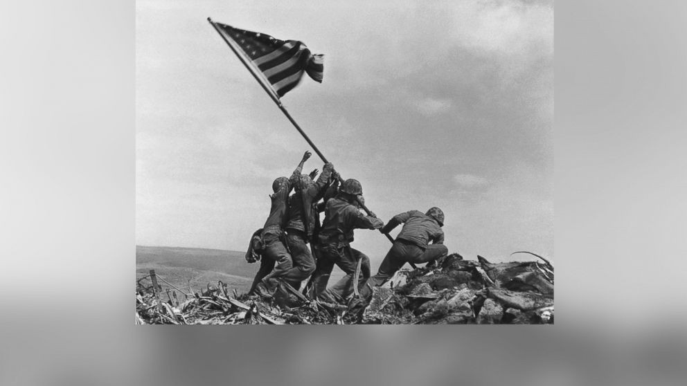 U.S. Marines of the 28th Regiment, 5th Division, raise the American flag atop Mt. Suribachi in Iwo Jima, Japan, Feb. 23, 1945.