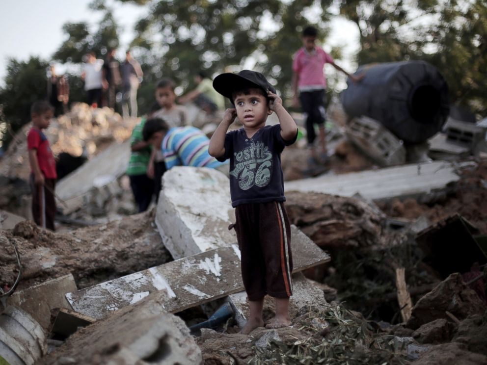 PHOTO: A Palestinian boy stands in the rubble of a destroyed house the day after an Israeli strike in the town of Beit Hanoun, Gaza Strip, July 9, 2014.