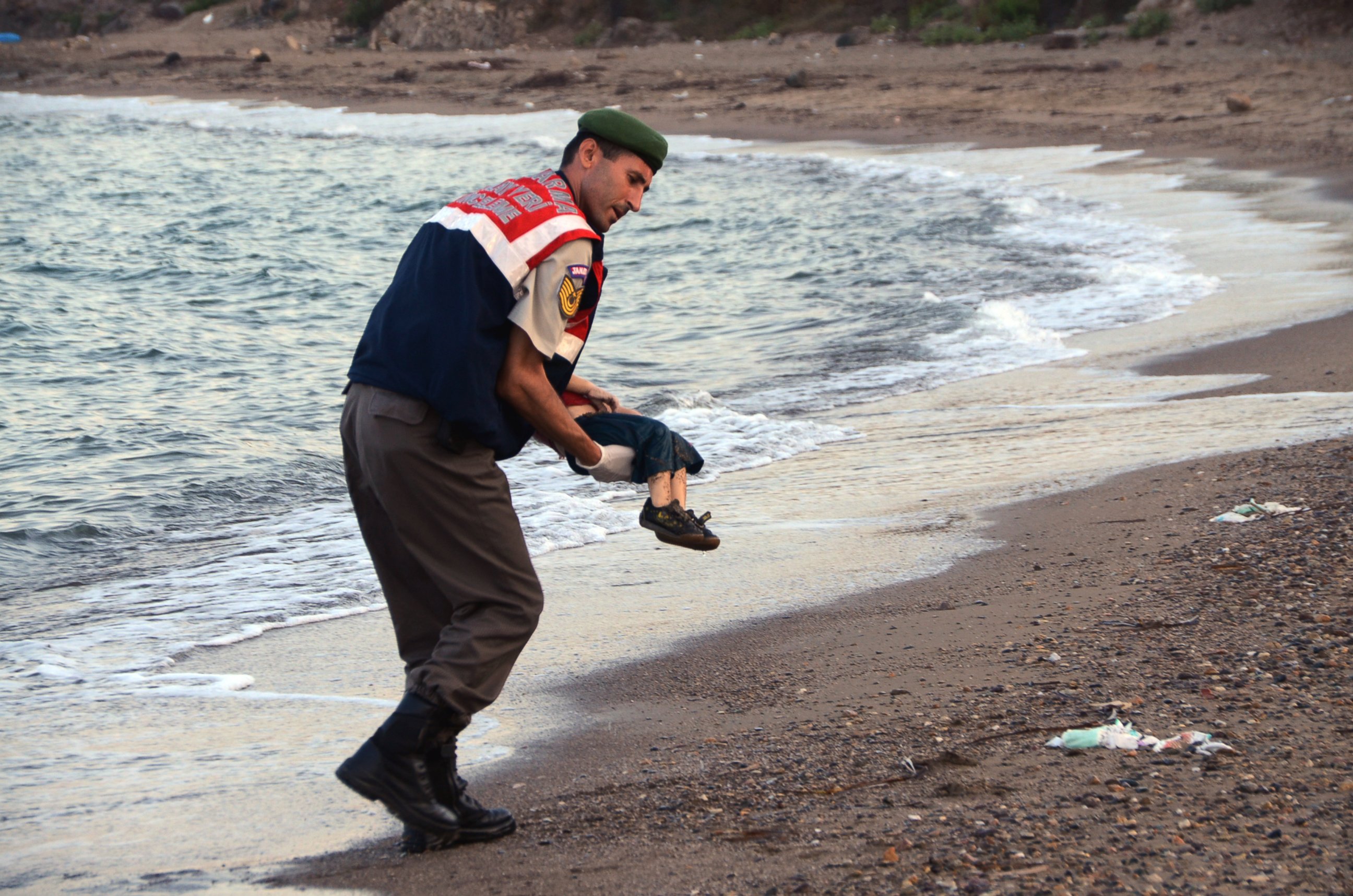 PHOTO:A paramilitary police officer carries the lifeless body of a migrant child after a number of migrants died after boats carrying them to the Greek island of Kos capsized,  Sept. 2, 2015. 