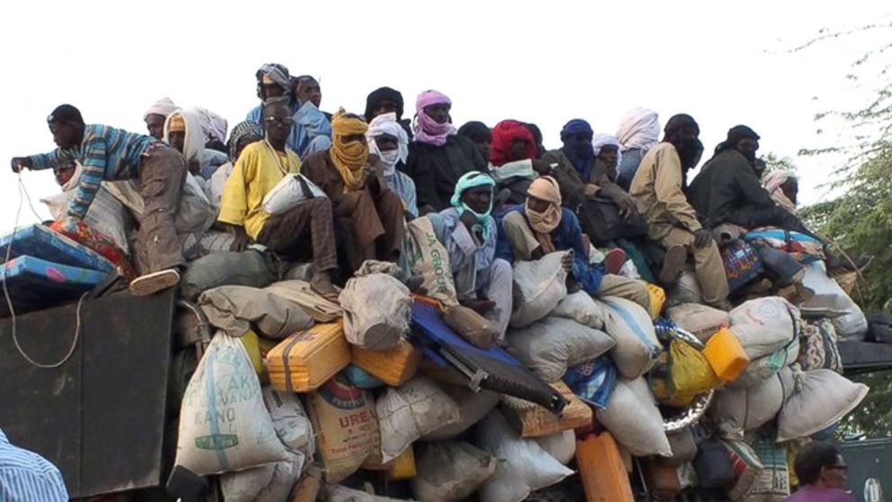 Migrants sit on top of a truck that is about to leave the city of Agadez, Niger, April 27, 2015. From here, they have to cross the desert to Libya or Algeria, as part of their journey towards Europe. 