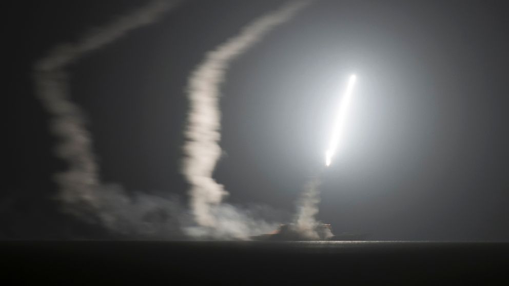 The guided-missile cruiser USS Philippine Sea launches a Tomahawk cruise missile at Islamic State group positions in Syria as seen from the aircraft carrier USS George H.W. Bush on the Arabian Gulf, Sept. 23, 2014.