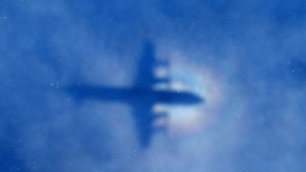 In this March 31, 2014 file photo, a shadow of a Royal New Zealand Air Force P-3 Orion aircraft is seen on low cloud cover while it searches for missing Malaysia Airlines Flight MH370 in the southern Indian Ocean. 
