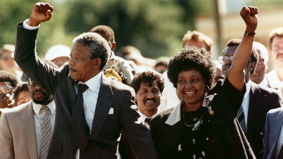 Nelson Mandela, left, and his wife Winnie, raise clenched fists as they walk hand-in-hand from the Victor Verster prison near Cape Town, South Africa, Feb. 11, 1990. 