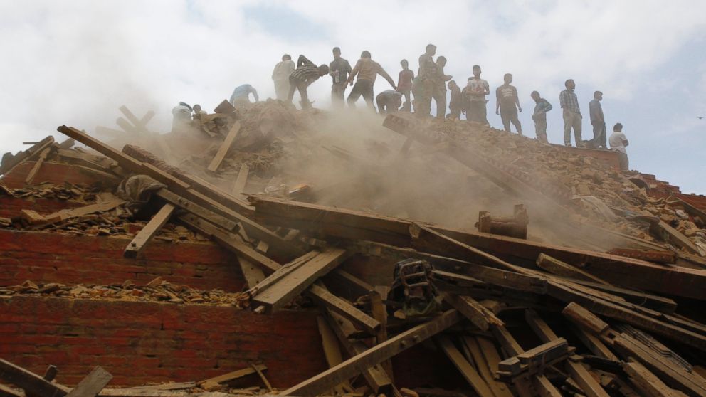 PHOTO: Volunteers help remove debris of a building that collapsed at Durbar Square, after an earthquake in Kathmandu, Nepal, Saturday, April 25, 2015.  