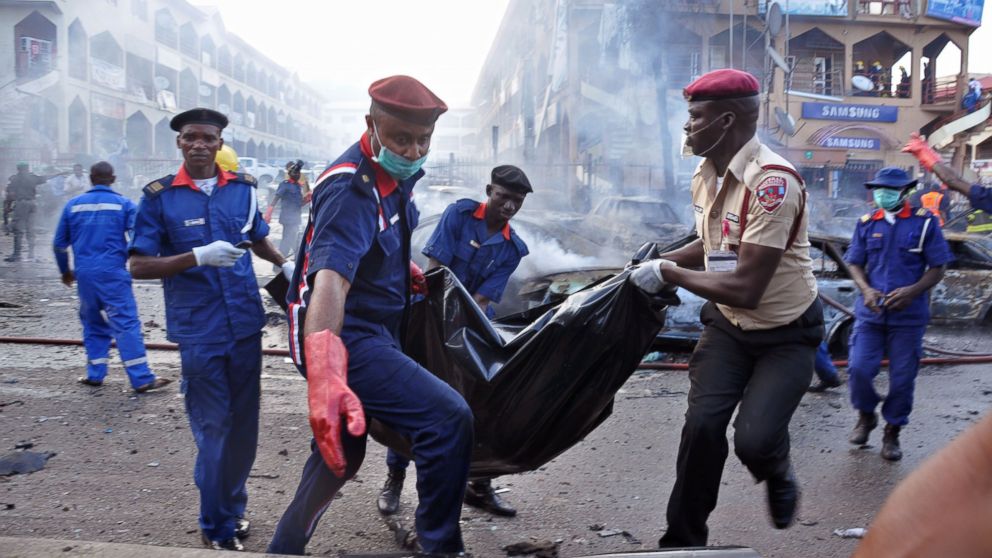 PHOTO: Rescue workers carry a body bag after a explosion at a shopping mall in Abuja, Nigeria