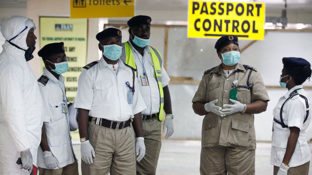 Nigeria health officials wait to screen passengers at the arrival hall of Murtala Muhammed International Airport in Lagos, Nigeria, Aug. 4, 2014. 