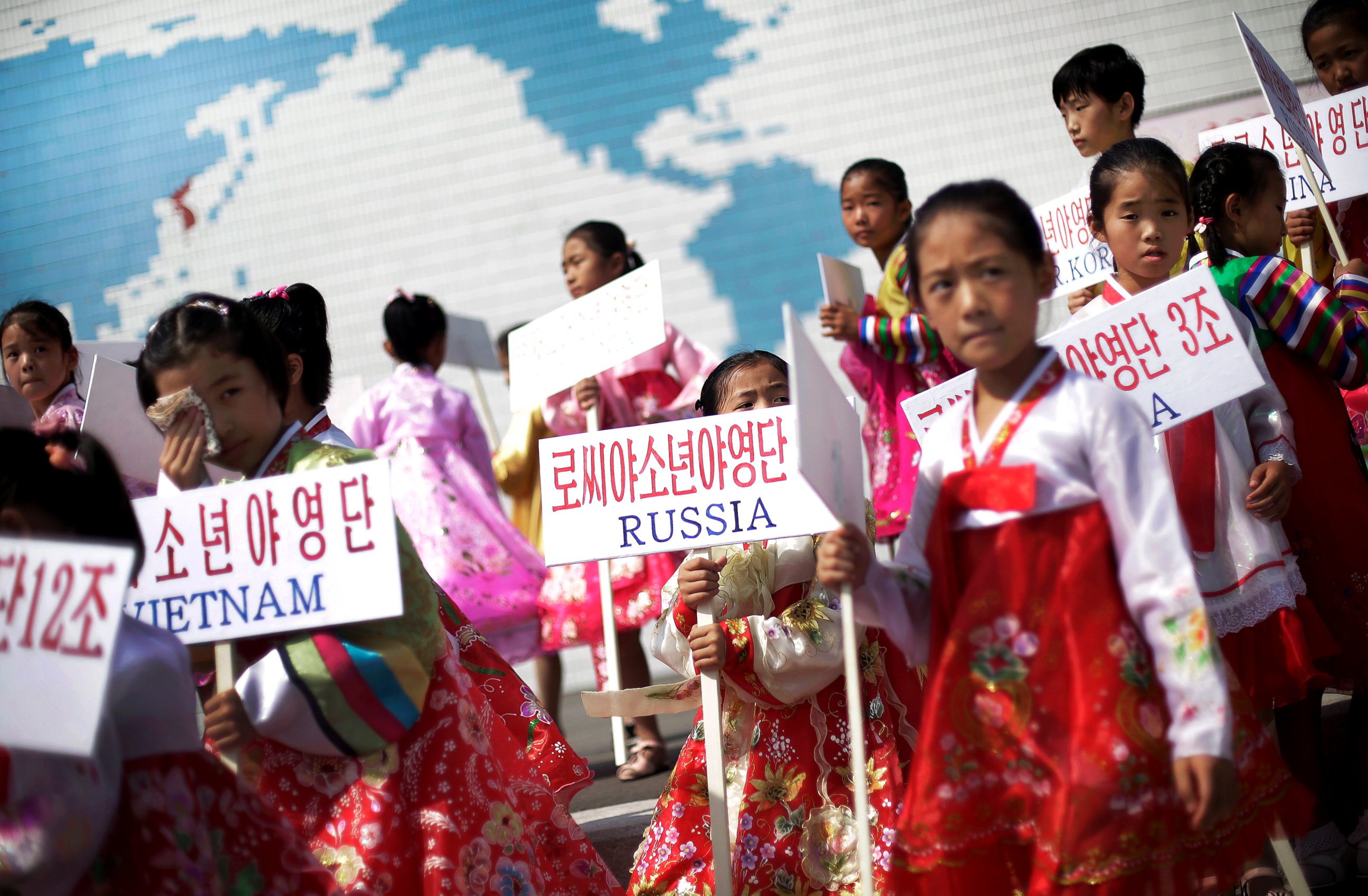 PHOTO: Young North Korean girls hold up signboards with the names of participating countries during an opening ceremony at the Songdowon International Children's Camp, July 29, 2014, in Wonsan, North Korea.