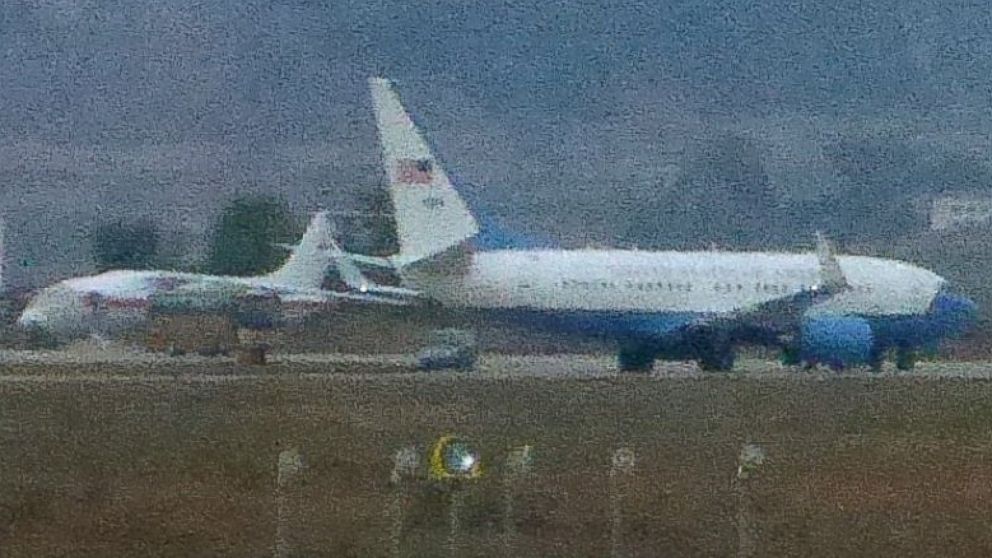 PHOTO: A United States Air Force passenger jet, right, is parked in Pyongyang, North Korea