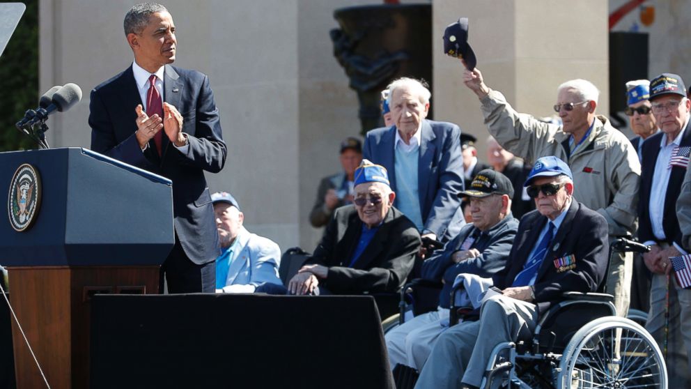 President Barack Obama acknowledges veterans as he speaks at Normandy American Cemetery at Omaha Beach as he participates in the 70th anniversary of D-Day in Colleville sur Mer in Normandy, France, June 6, 2014.