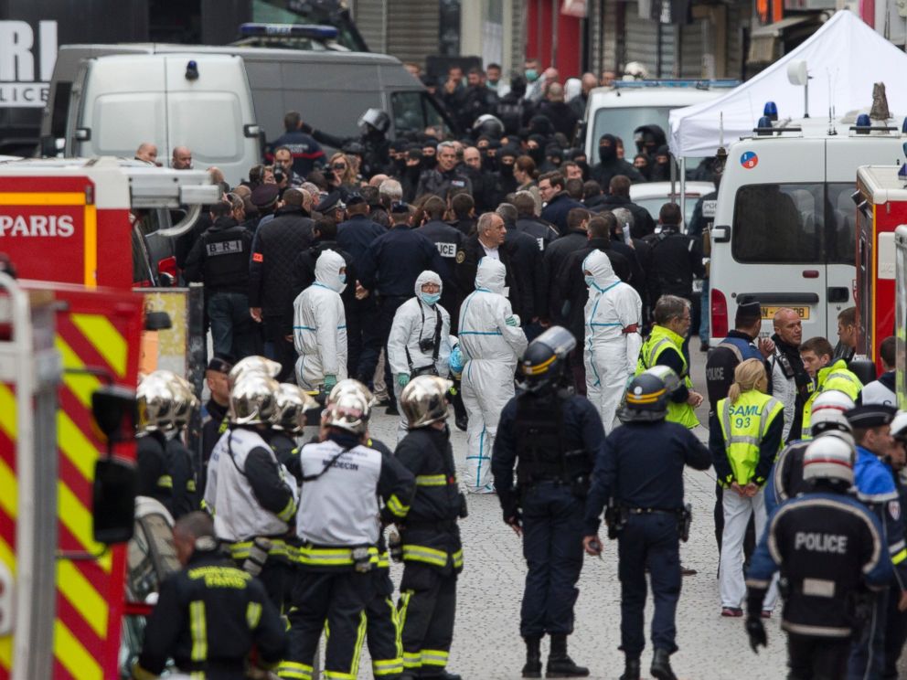 PHOTO: Forensic experts in white suits wait for a go ahead after an operation of security forces against a group of extremists in Saint Denis, near Paris, Nov. 18, 2015.