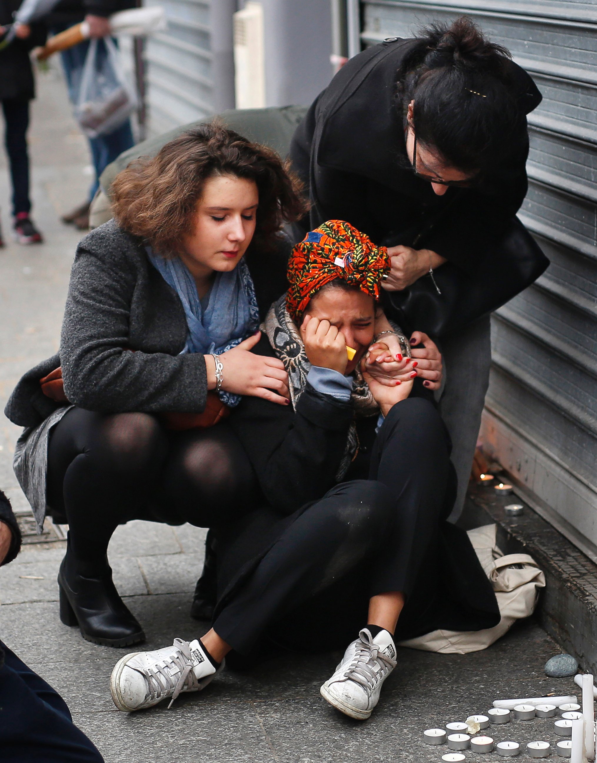 PHOTO: A woman is comforted by others outside the Carillon cafe and the Petit Cambodge restaurant in Paris, Nov. 14, 2015, a day after over 120 people were killed in a series of attacks in Paris.