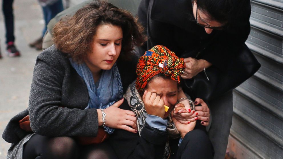 PHOTO: A woman is comforted by others outside the Carillon cafe and the Petit Cambodge restaurant in Paris, Nov. 14, 2015, a day after over 120 people were killed in a series of attacks in Paris.