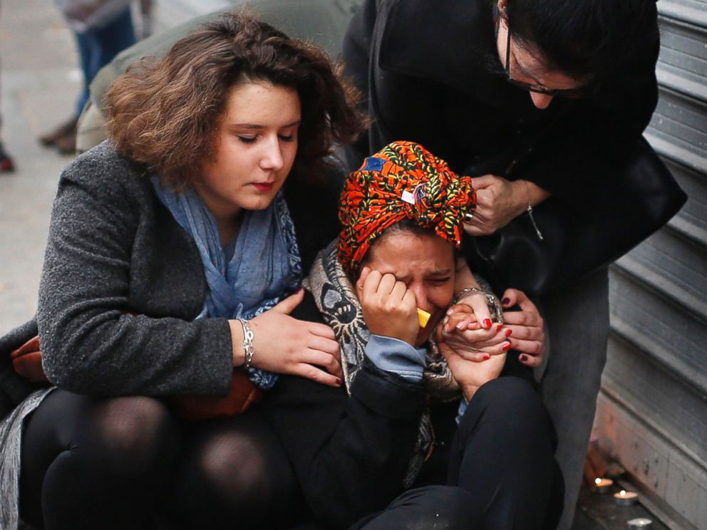 PHOTO: A woman is comforted by others outside the Carillon cafe and the Petit Cambodge restaurant in Paris, Nov. 14, 2015, a day after over 120 people were killed in a series of attacks in Paris.