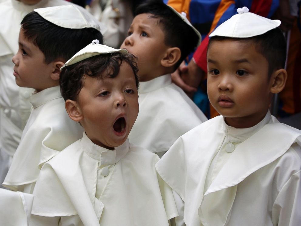 PHOTO: A boy dressed as a Pope, yawns as he prepares to join a parade in celebration of the canonization or the elevation to sainthood in the Vatican of Roman Catholic Pope John Paul II and Pope John XXIII Sunday, April 27, 2014 in the Philippines.