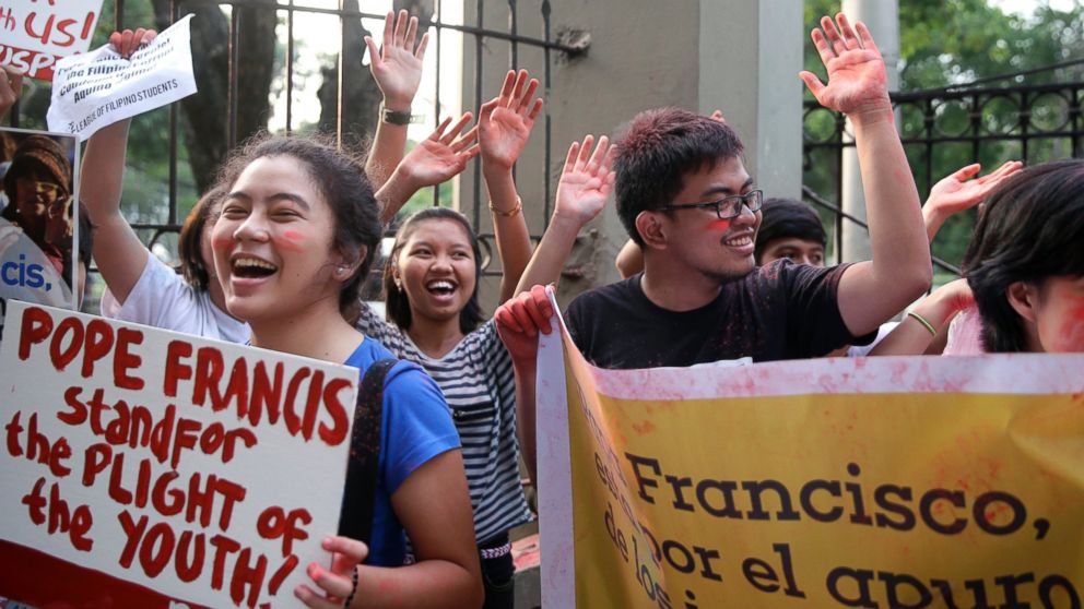 Youth and students shout "Welcome Pope Francis" after throwing colored powder in the air at the start of the countdown to welcome the Pontiff, Jan. 14, 2015 in Manila, Philippines.
