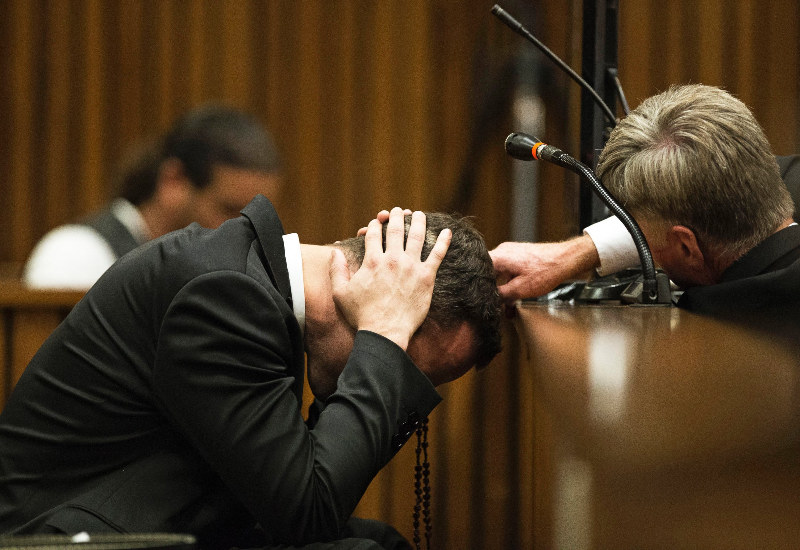 PHOTO: Oscar Pistorius, listens to evidence from a witness speaking about the morning of the shooting of his girlfriend Reeva Steenkamp, in court on the fourth day of his trial at the high court in Pretoria, South Africa, March 6, 2014.  