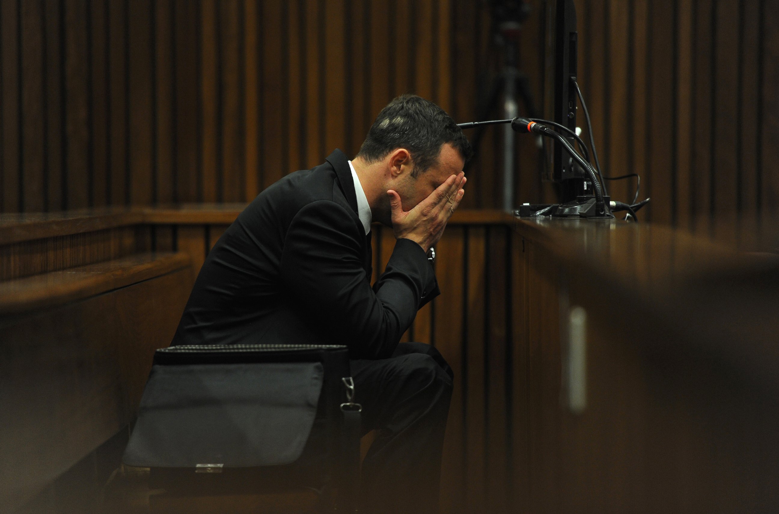 PHOTO: Oscar Pistorius listens to evidence from a witness speaking about the morning of the shooting of his girlfriend Reeva Steenkamp on the fourth day of his trial at the high court in Pretoria, South Africa, March 6, 2014.  
