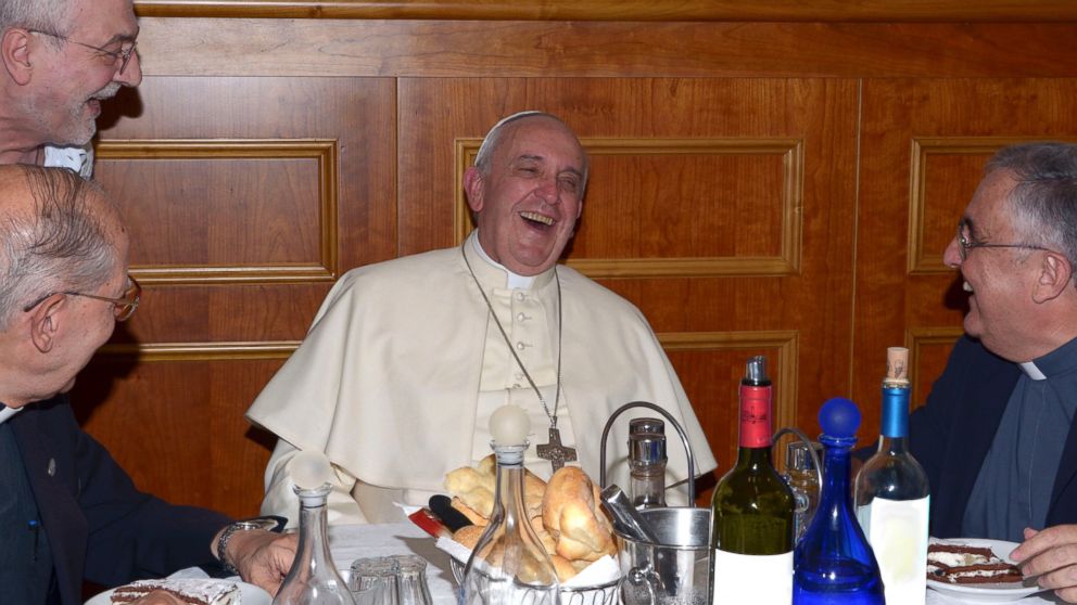 Pope Francis shares a laugh with Rev. Adolfo Nicolas, left, Father Jaquin Barrero, right, and Father Attilio Sciortino during their meeting at the Jesuit Curia in Rome, July 31, 2014. 