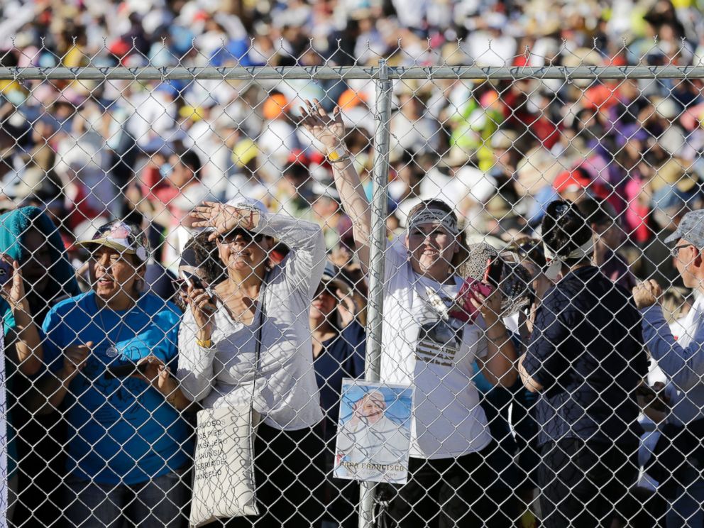 PHOTO: People wait to get a glimpse of Pope Francis as he arrives to celebrate an outdoor Mass in Ciudad Juarez, Mexico, Feb. 17, 2016. 