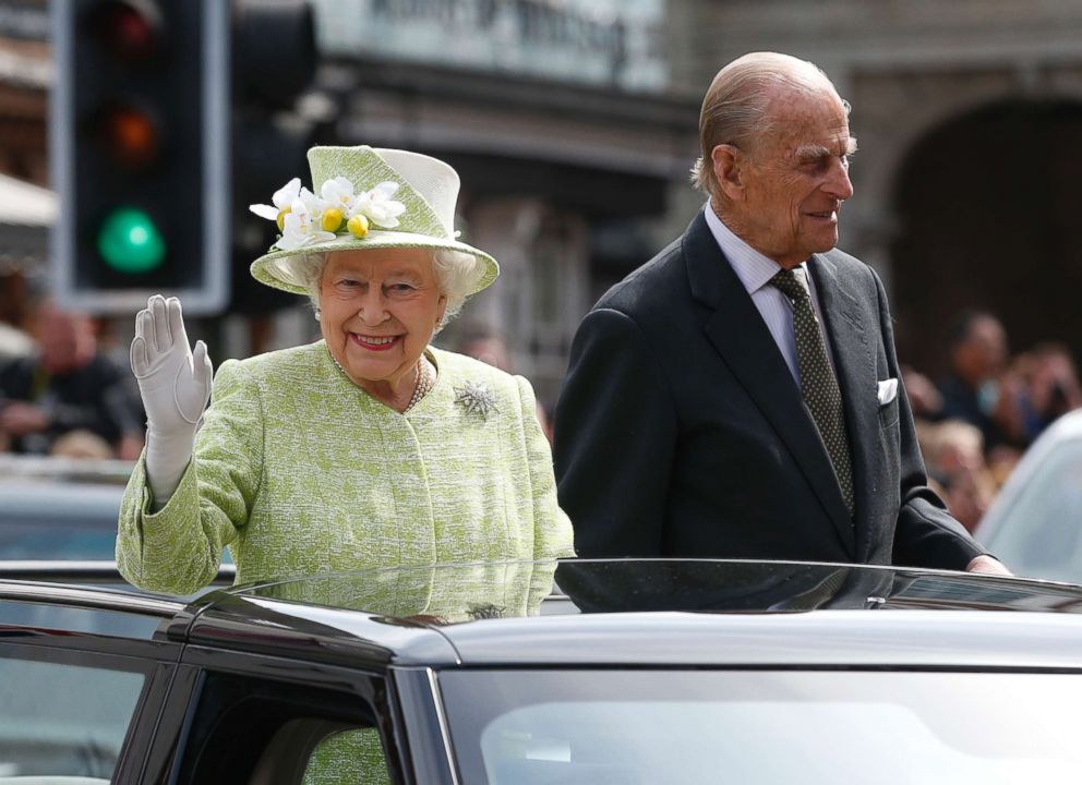 PHOTO: Queen Elizabeth II waves to the crowds as she rides with Prince Phillip in a open top car to celebrates her 90th birthday in Windsor, Britain, April, 21, 2016.