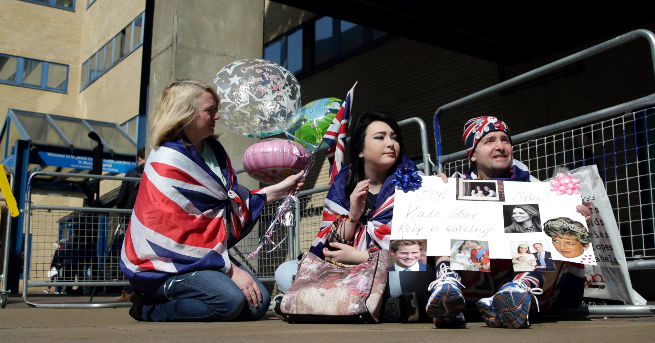 PHOTO: Royal fans Maria Scott, left Amy Thompson and John Loughrey wait outside the Lindo Wing at St Mary's Hospital in London, April 20, 2015.
