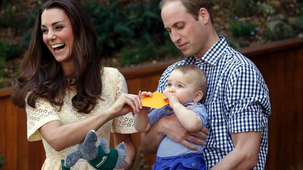 PHOTO: Britain's Kate, the Duchess of Cambridge, and her husband Prince William react as their son Prince George bites a small present that was given to him during a visit to Sydney's Taronga Zoo, Australia Sunday, April 20, 2014. 