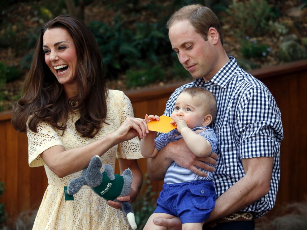 PHOTO: Britain's Kate, the Duchess of Cambridge, and her husband Prince William react as their son Prince George bites a small present that was given to him during a visit to Sydney's Taronga Zoo, Australia Sunday, April 20, 2014. 