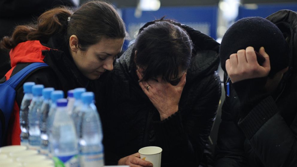 A Russian Emergency Situations Ministry employee, left, tries to comfort a relative of the plane crash victims at the Rostov-on-Don airport, about 950 kilometers (600 miles) south of Moscow, Russia Saturday, March 19, 2016. An airliner from Dubai crashed early Saturday while landing in the southern Russian city of Rostov-on-Don in strong winds, Russian officials said.