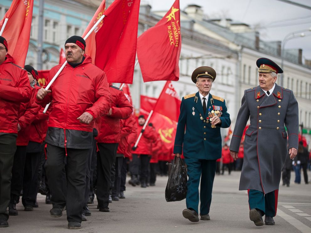 PHOTO: Demonstrators wearing red and two WWII veterans, right, march in support of Kremlin-backed plans for the Ukrainian province of Crimea to break away and merge with Russia, in Moscow, Saturday, March 15, 2014.