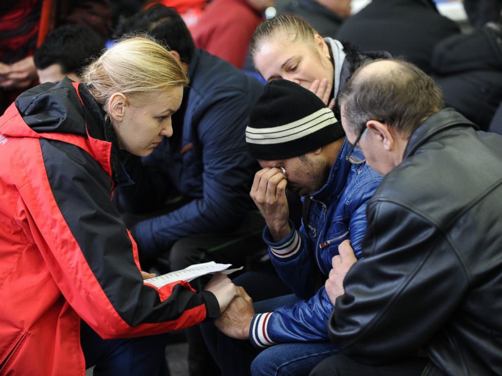 PHOTO: A Russian Emergency Situations Ministry employee, left, tries to comfort a relative of the plane crash victims at the Rostov-on-Don airport, Russia, March 19, 2016.