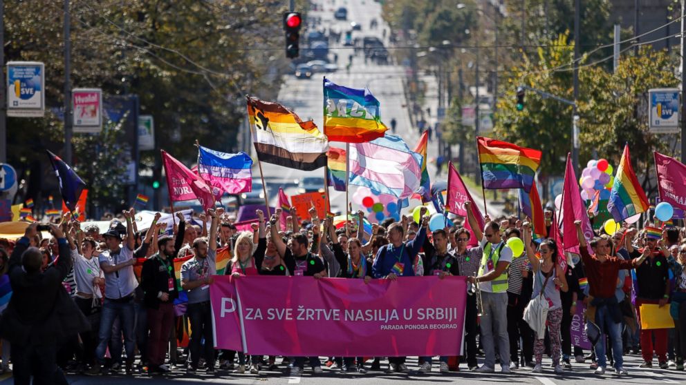 Gay activists wave flags during the Pride March in Belgrade, Serbia, Sept. 28, 2014.