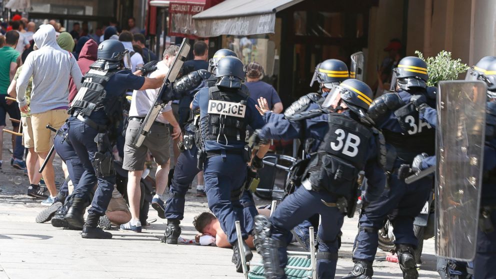 French police officers charge soccer supporters during clashes in downtown Marseille, France,  June 11, 2016. 