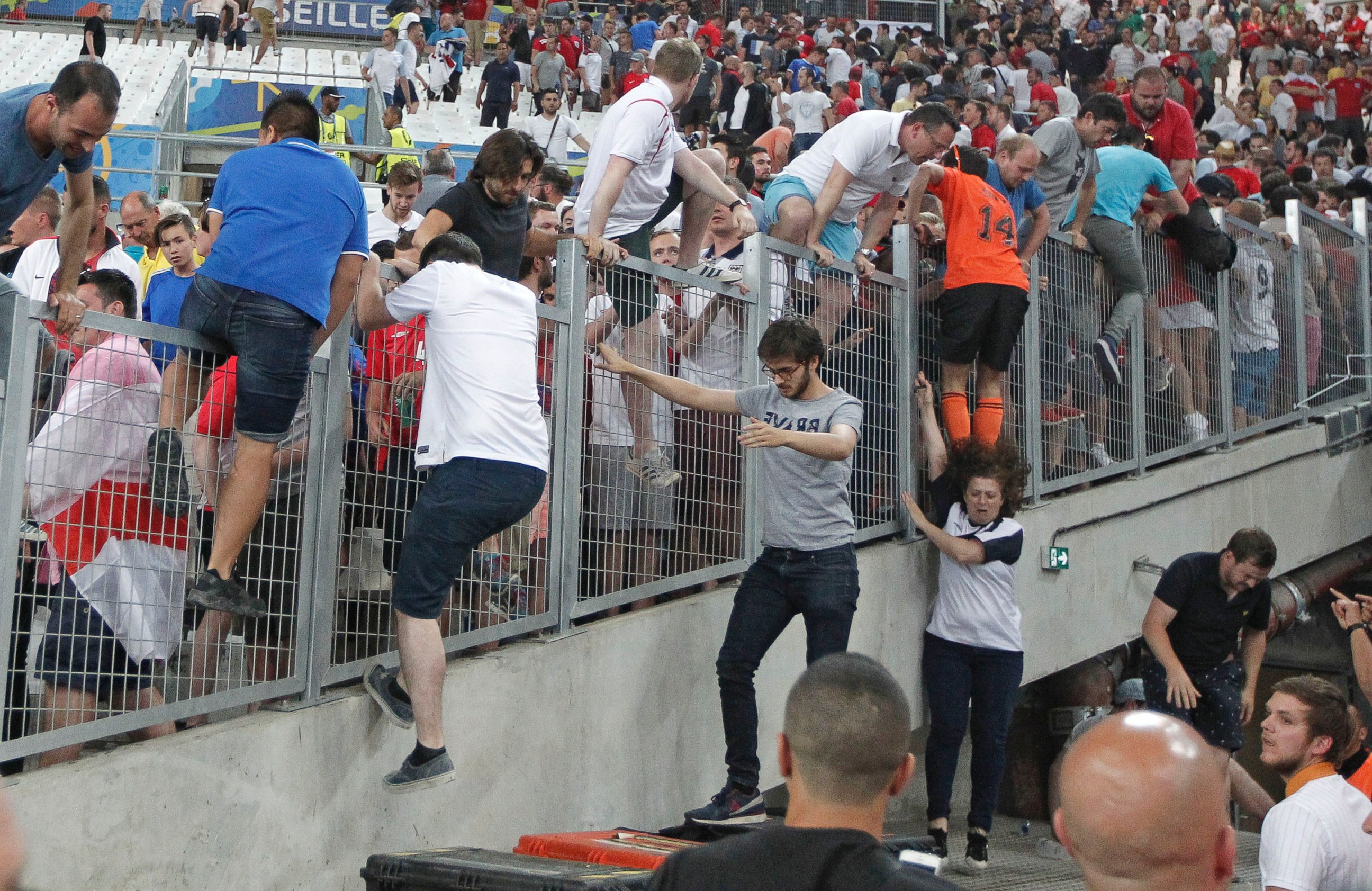 PHOTO: Spectators try to escape from Russian supporters who went on a charge in the stands right after the Euro 2016 Group B soccer match between England and Russia, at the Velodrome stadium in Marseille, France, June 11, 2016.