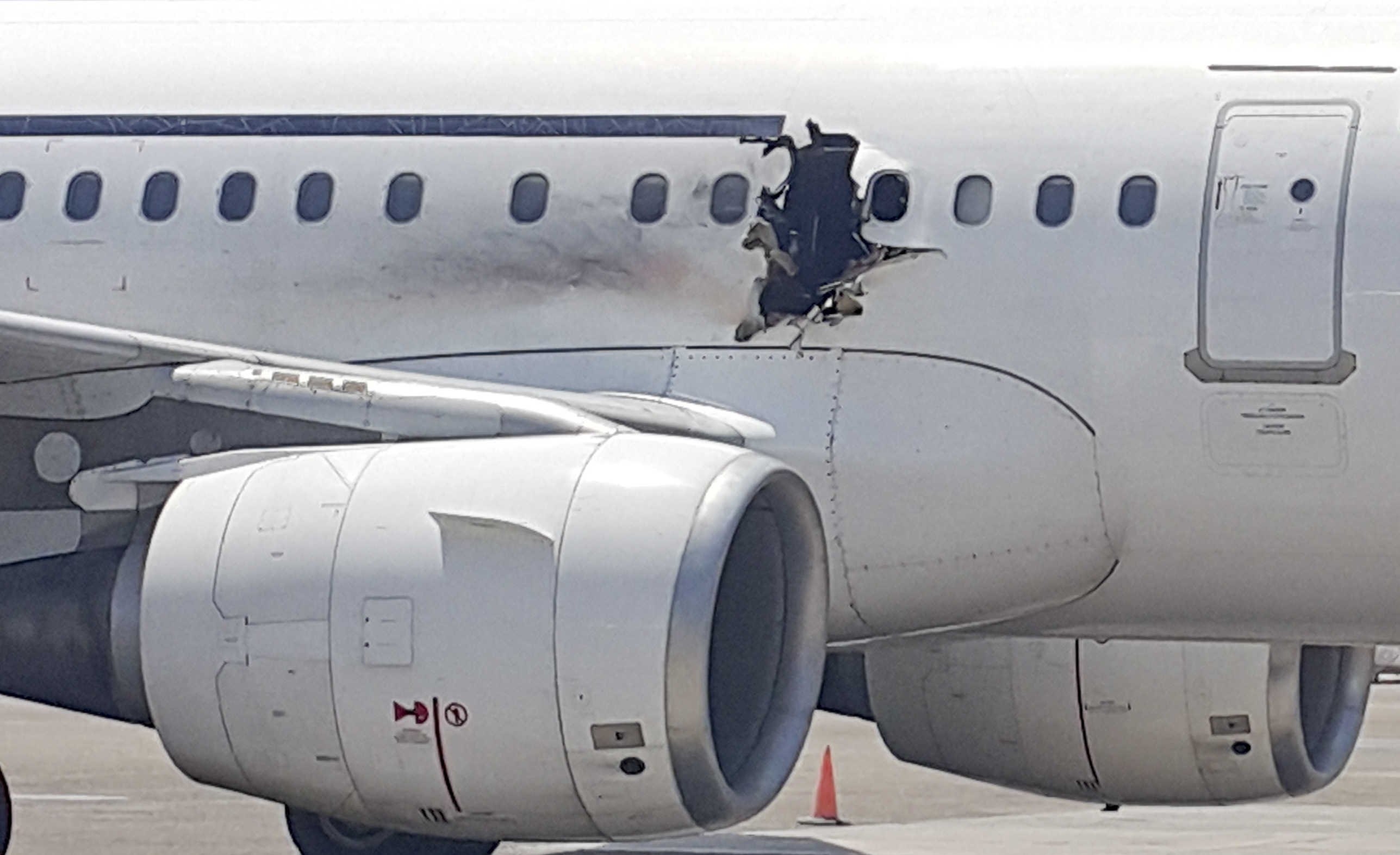 PHOTO:A hole is seen in a plane operated by Daallo Airlines as it sits on the runway of the airport in Mogadishu, Somalia, Feb. 2, 2016.   