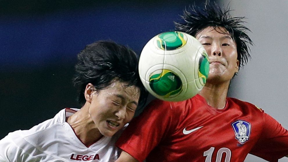 PHOTO: South Korea's Ji So-yun, right, fights for the ball against North Korea's Kim Un Hyang during their Women's East Asian Cup soccer match at Seoul World Cup stadium in Seoul, South Korea, Sunday, July 21, 2013. North Korea won 2-1. 