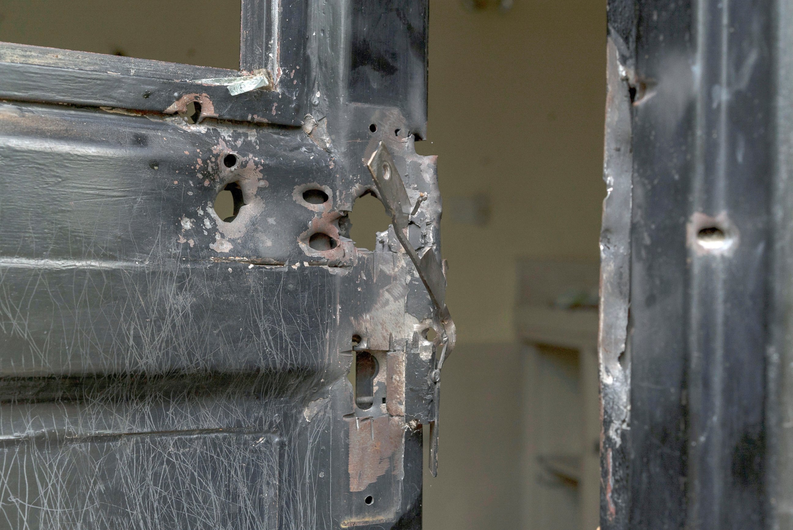 PHOTO: Bullet holes are seen in a metal door that was shot open at the Terrain compound after it was looted the previous month in the capital Juba, South Sudan, Aug. 3, 2016.