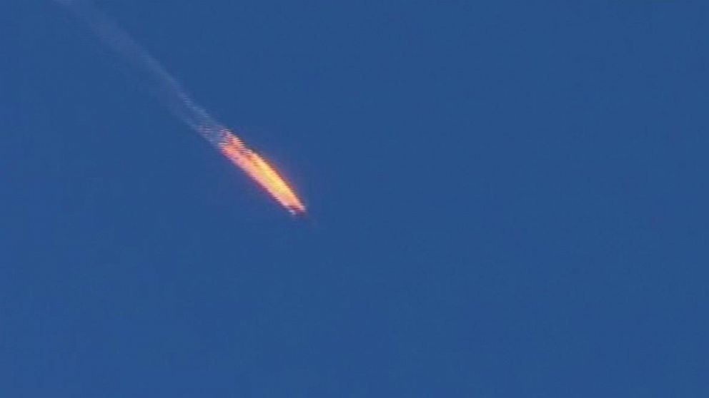 This video frame grab shows a Russian warplane on fire before crashing on a hill as seen from Hatay province, Turkey, Nov. 24, 2015.  