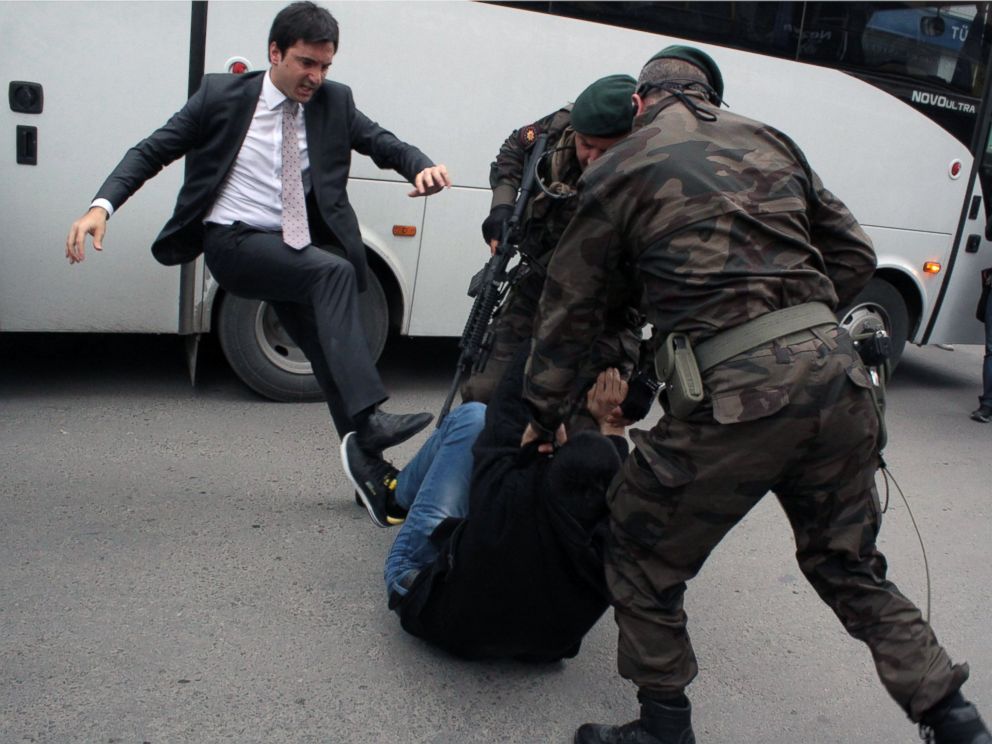 PHOTO: A person identified by Turkish media as Yusuf Yerkel, advisor to Turkish Prime Minister Recep Tayyip Erdogan, kicks a protester already held by special forces police members during Erdogans visiting Soma, Turkey, May 14, 2014.