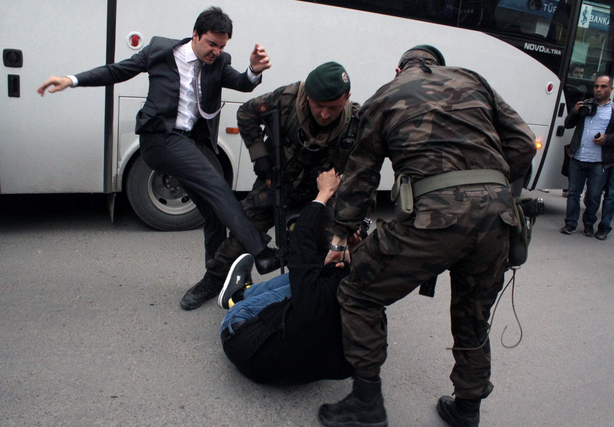 PHOTO: A person identified by Turkish media as Yusuf Yerkel, advisor to Turkish Prime Minister Recep Tayyip Erdogan, kicks a protester already held by special forces police members during Erdogan's visiting  Soma, Turkey, May 14, 2014.