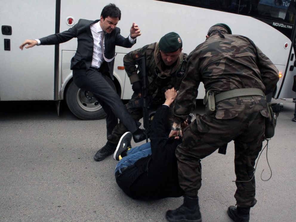 PHOTO: A person identified by Turkish media as Yusuf Yerkel, advisor to Turkish Prime Minister Recep Tayyip Erdogan, kicks a protester already held by special forces police members during Erdogans visiting Soma, Turkey, May 14, 2014.