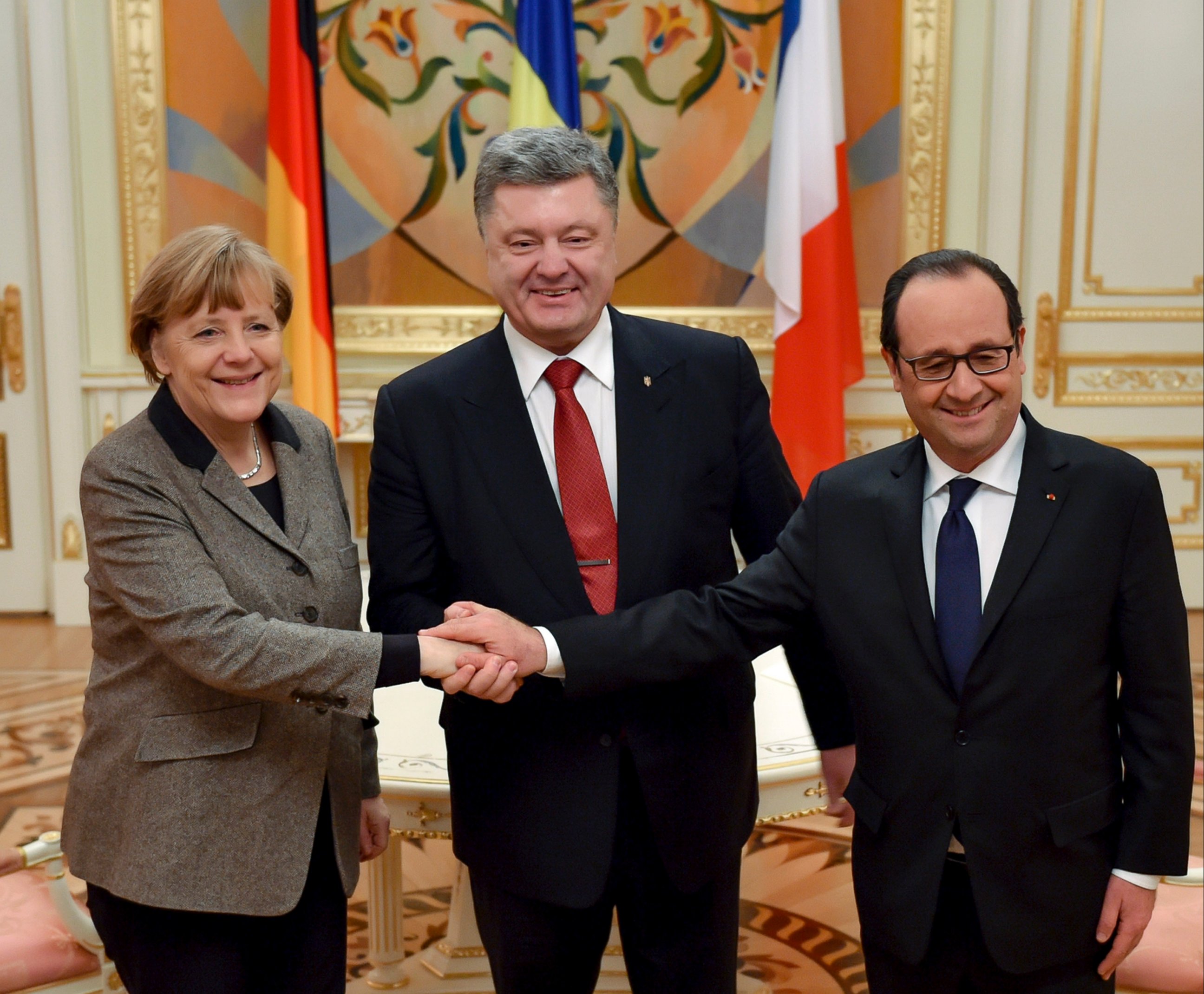 PHOTO: Ukrainian President Petro Poroshenko, center, French President Francois Hollande, right, and German Chancellor Angela Merkel shake hands during their meeting in Kiev, Ukraine, Feb. 5, 2015.
